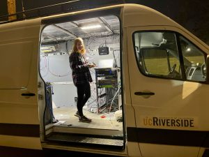 image of a woman in a UC Riverside van, with research equipment